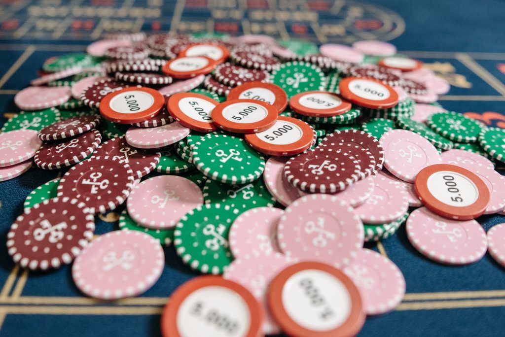 A colorful pile of poker chips on a casino table in a close-up view, emphasizing gambling concepts.